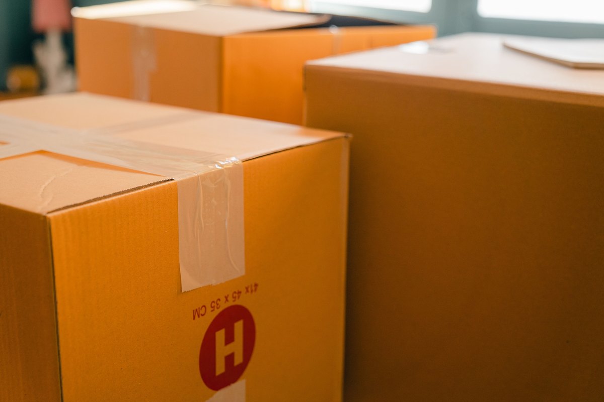 Close view of taped orange-brown cardboard moving boxes